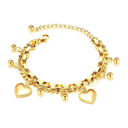 Gold bracelet with heart charms on a white background