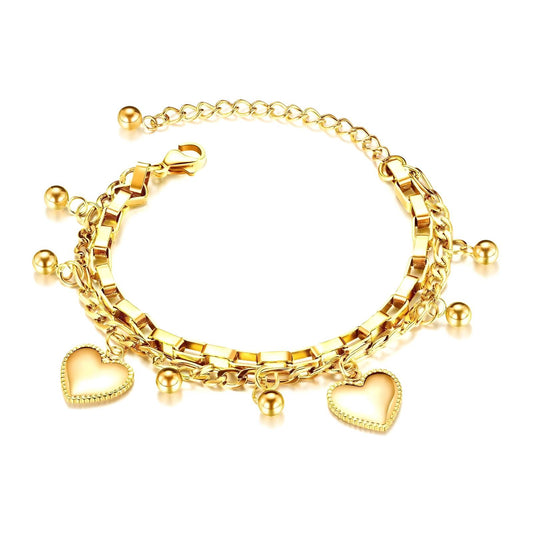 Gold bracelet with heart charms on a white background